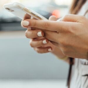 young woman glued to her iphone